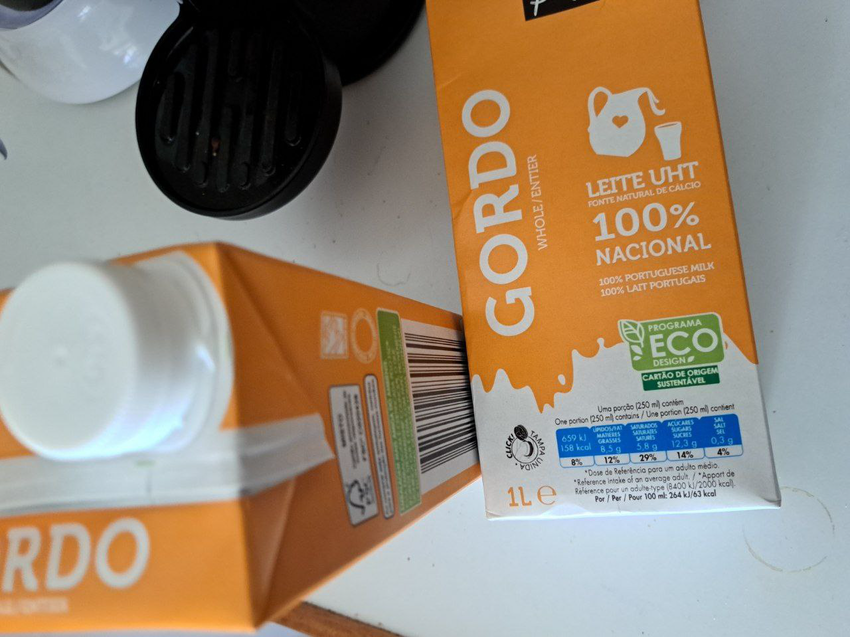 a picture of two milk packets, that have an "ecodesign" mark, but also plastic lids